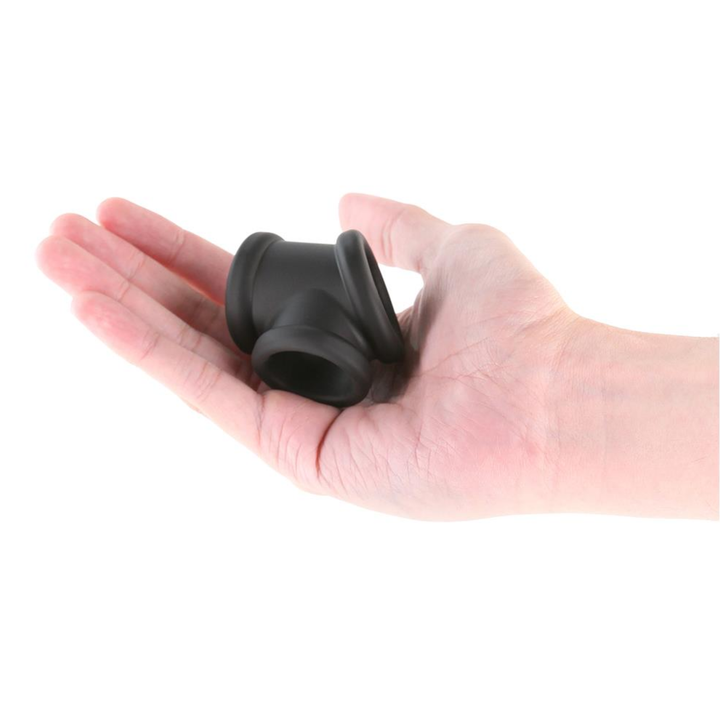 hand holding Constriction Cock Ring plus Ball Stretcher  