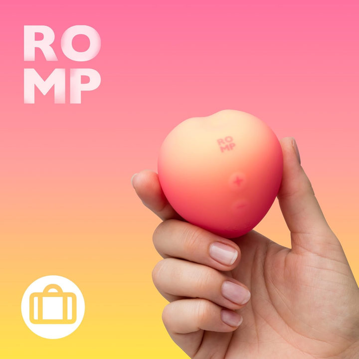 hand holding ROMP Pink Peach Rechargeable Clitoral Stimulator 