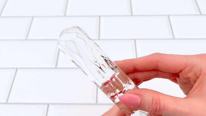 GIF of tingling lube rubbed on a clear glass dildo