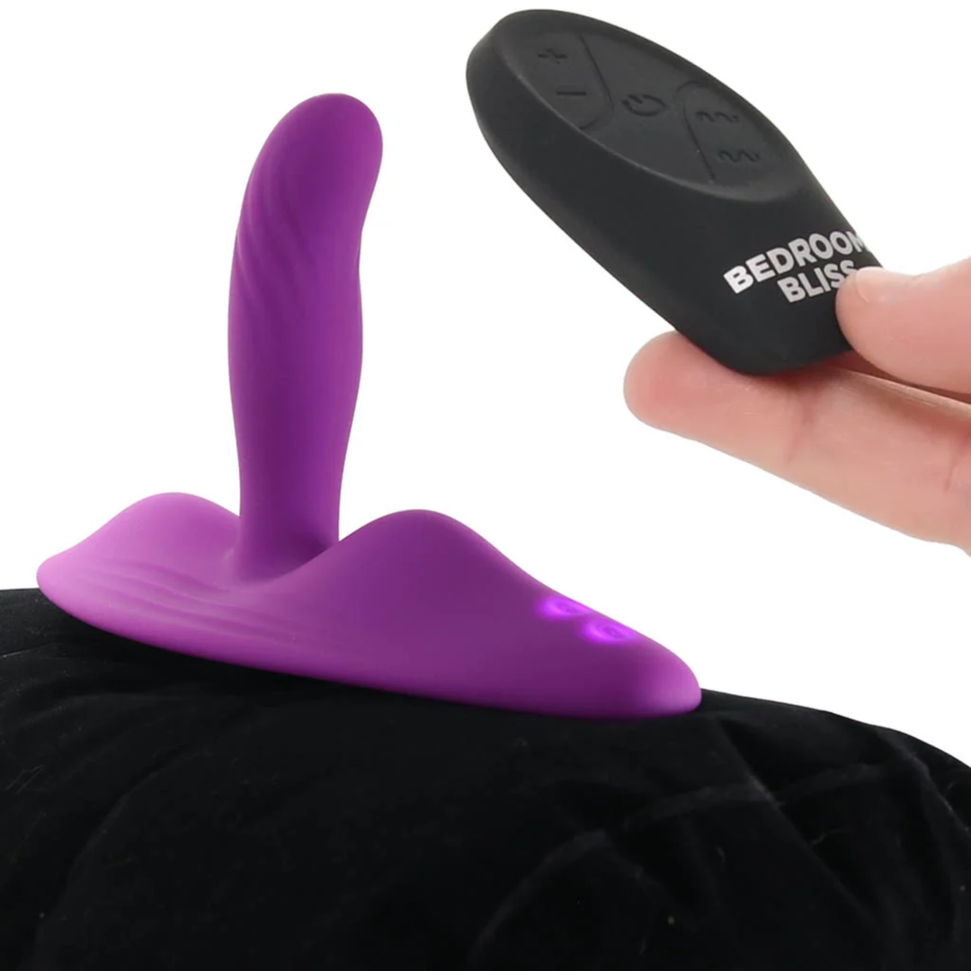 hand holding remote control from Bedroom Bliss Love Rider Vibrating Cushion