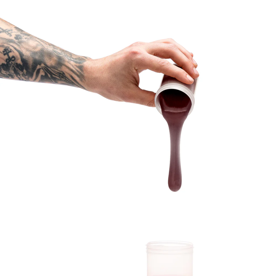 hand pouring dark brown silicone into Clone-A-Willy Silicone Dildo Molding Kit with Vibrator mold 