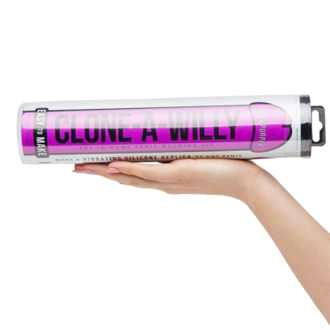 hand holding Clone-A-Willy Silicone Dildo Molding Kit with Vibrator - Neon Purple   