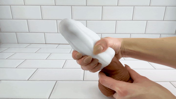 GIF of Cherry Blossom Masturbator Egg being used on thick dildo to show flexibility 
