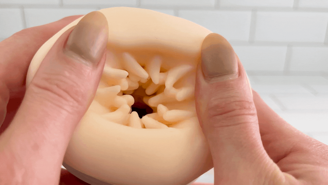 GIF of Super Series Pro Auto-Thrusting Masturbator opening hole being stretched to show flexibility 