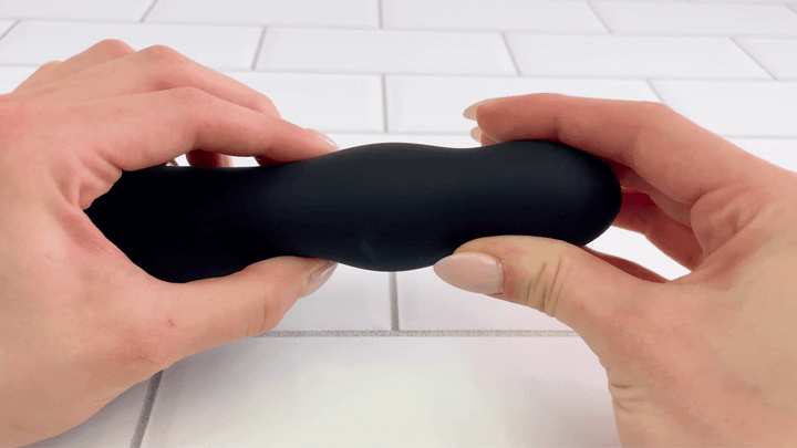 GIf of 7 Inch Silicone Vibrating Hollow Strap-on dildo shaft being squished to show soft silicone material 