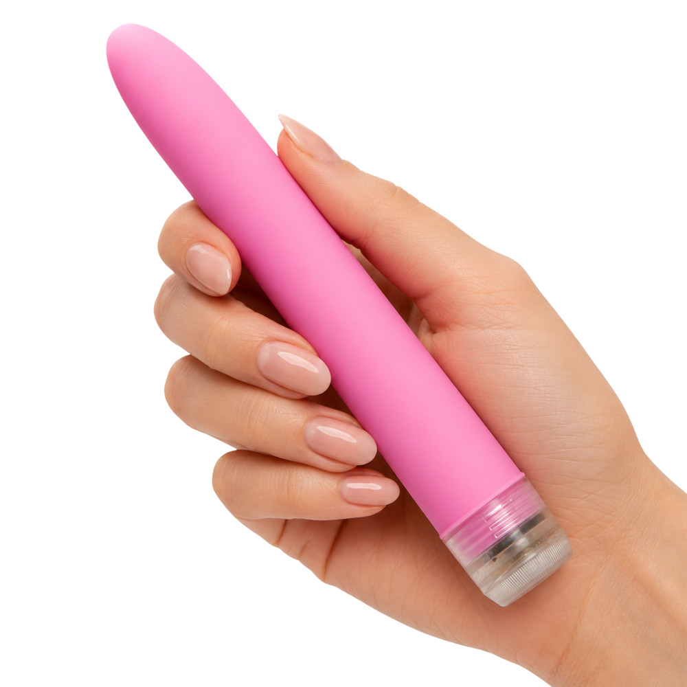 A hand with manicured nails holding a pink sleek multi-speed vibe with a clear, transparent base against a solid white background.