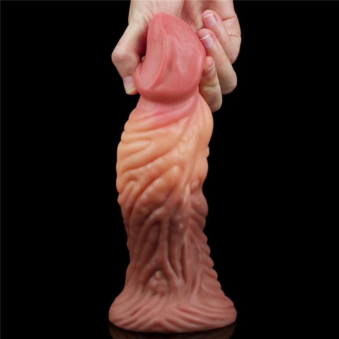 hands pulling tip from Dual-Density Fantasy Cock layered Platinum Silicone Plug from Lovetoy 