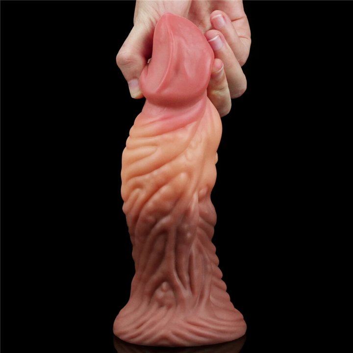 hands pulling tip from Dual-Density Fantasy Cock layered Platinum Silicone Plug from Lovetoy 