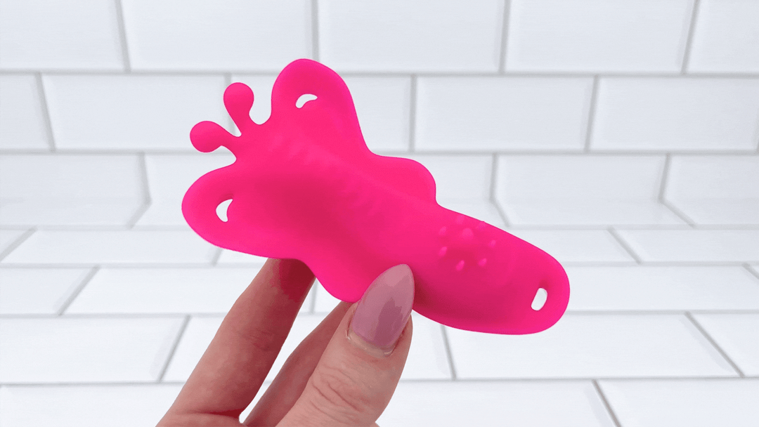GIF of hand holding Wearable Butterfly Vibrator powered on 