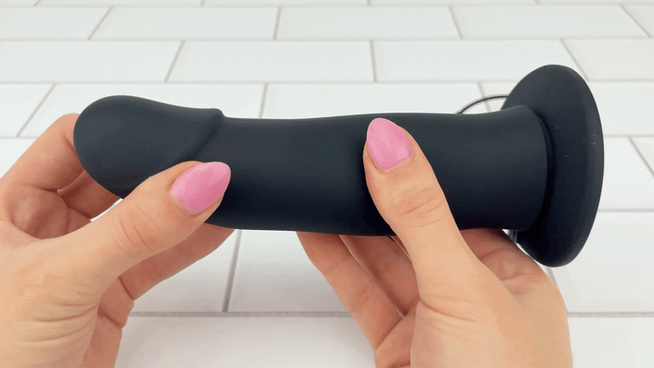 GIF of Vibrating Silicone Hollow Strap On shaft being squished to show texture 
