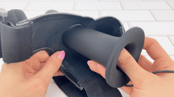 GIF of Vibrating Silicone Hollow Strap On being inserted inside harness 