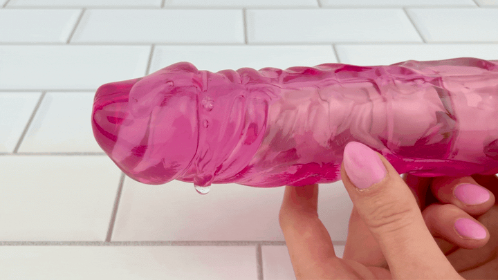 GIF of lubricant vibrating on top speed TooTimid pink thick dildo vibrator 