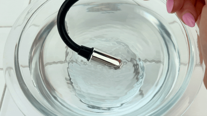 GIF of bent Flexi Clit Wand vibrating in bowl of water 