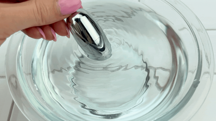 GIF of silver bullet vibe on low speed vibrating in water bowl 