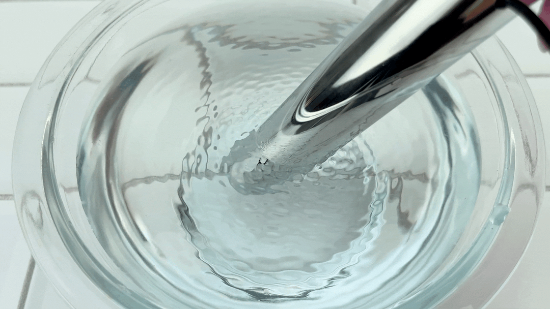 GIF of Silver Power Vibe & Clit Bullet on high setting vibrating in bowl of water 
