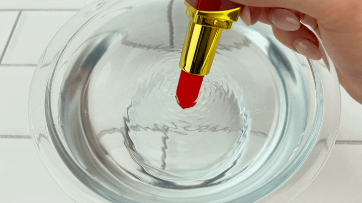 GIF of Rechargeable Lipstick Vibrator  tip vibrating on highest setting in bowl of water 