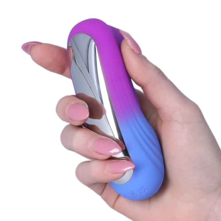 Hand holding a gradient purple to blue device against a white background