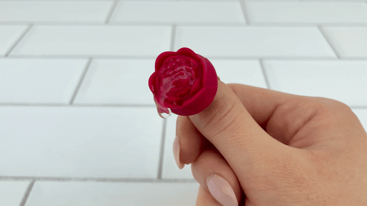 GIF of Rose Ring Vibrator on strongest setting with lubricant vibrating on top of it 