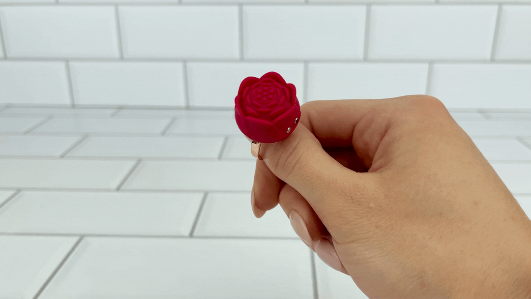GIF of hand holding Rose Ring Vibrator with power on 