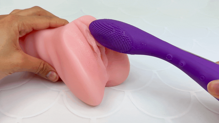 GIF of nubby end vibrating on a model of a clitoris