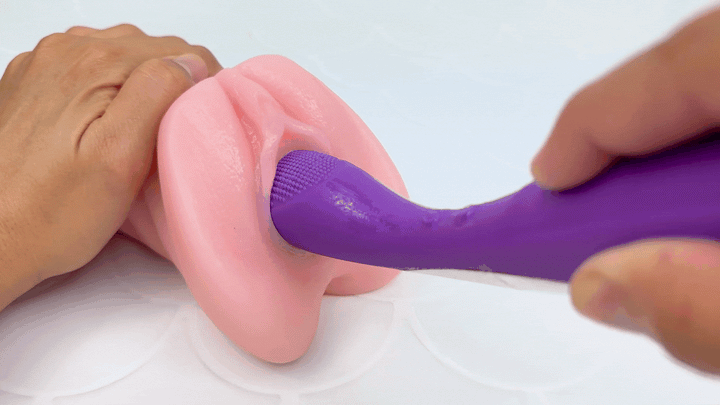 GIF of massager penetrating a model of a vagina