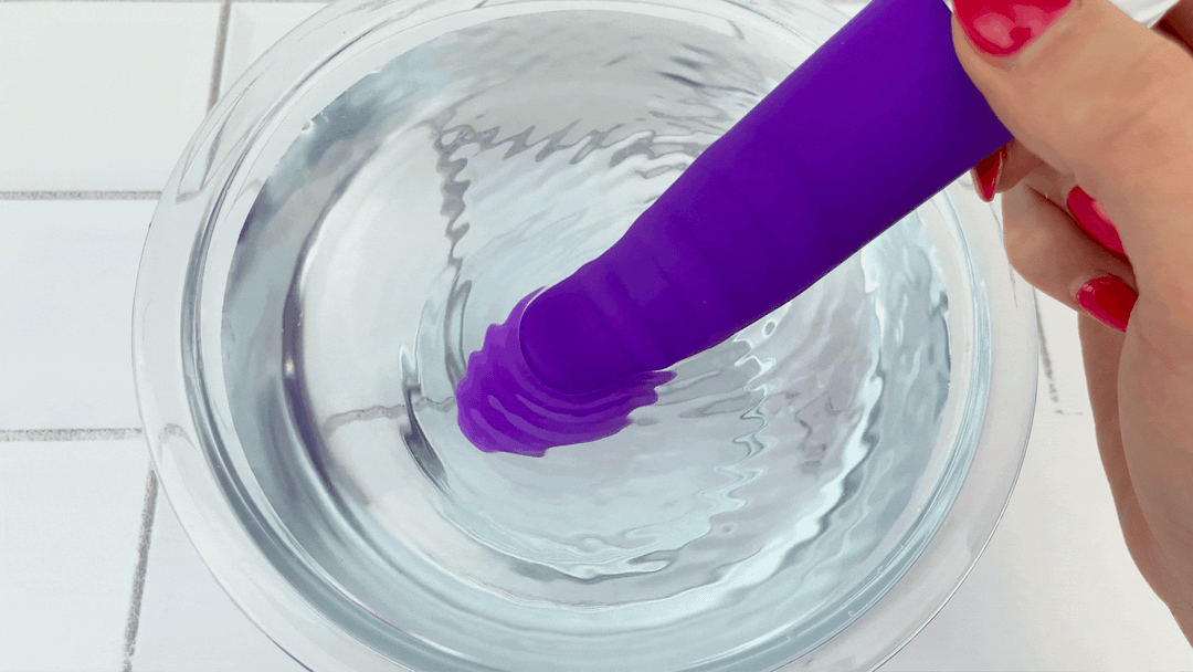 GIF of bulbous tip from rippled g-spot vibrator vibrating in bowl of water