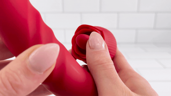 GIF of rose thrusting licking vibrator with hand moving petals to show soft silicone 