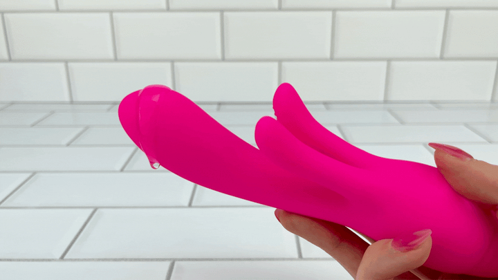 GIF of hand holding Silicone G-Spot Rabbit with lube dripping off 