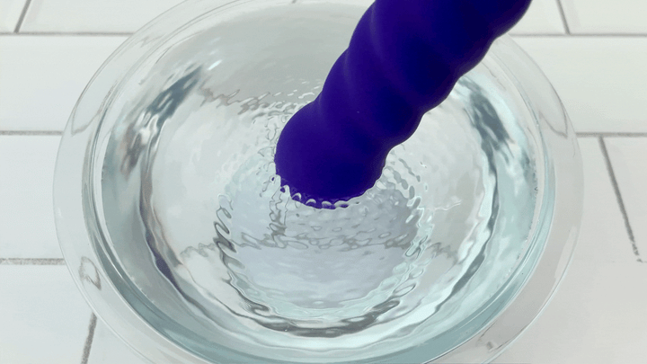 GIF of tip of The Swirl Rechargeable Silicone Vibrator vibrating in bowl of water 