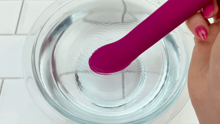 GIF of flexible g-spot pulsating on low speed in bowl of water maroon color 