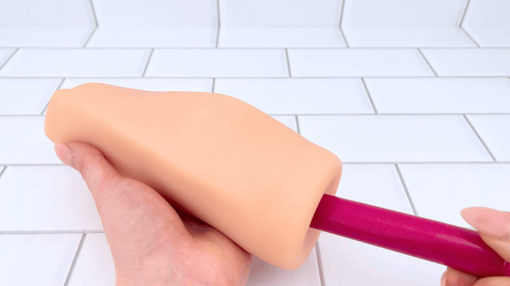 GIF of Rose G-Spot Vibrator used on a masturbation sleeve 