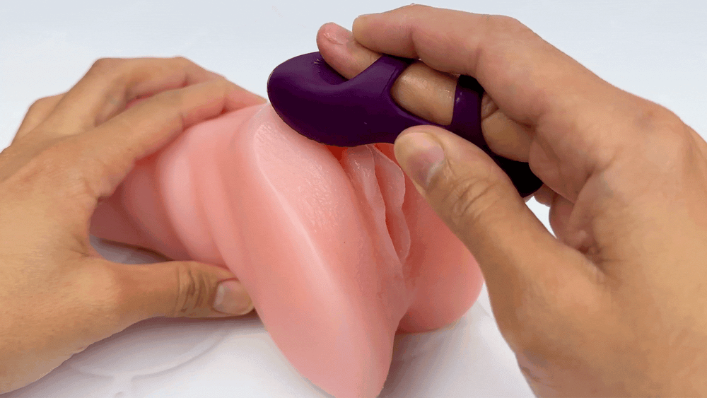 GIF of finger vibe being used to massage model of a clitoris