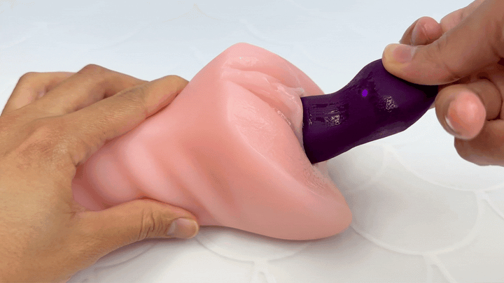 GIF of finger massager penetrating a model of a vagina