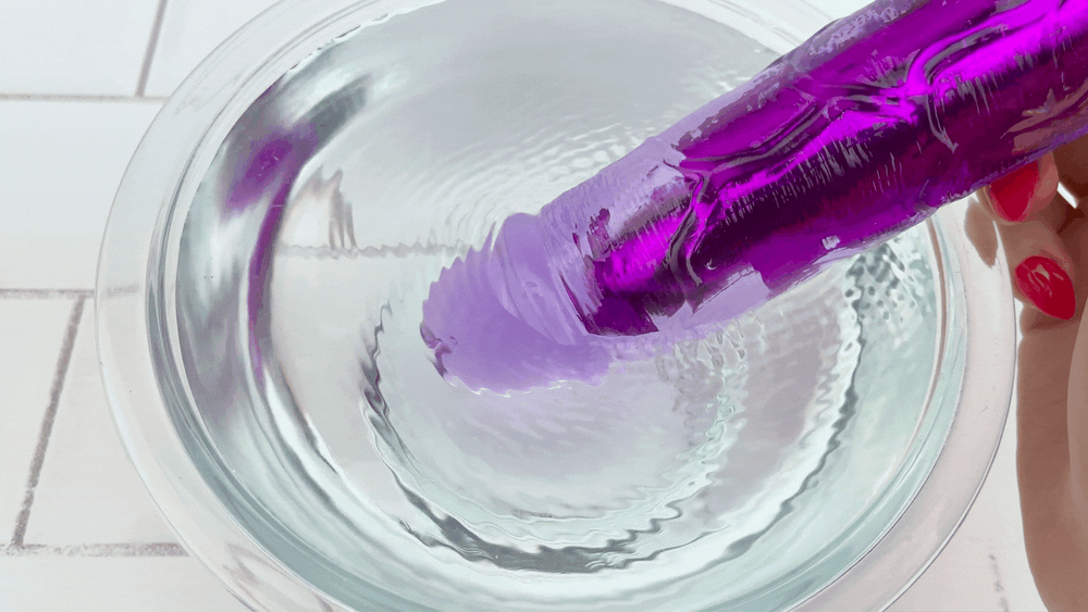 GIF of 8 Inch Long Deep Penetration Vibrating Dildo tip vibrating in bowl of water 