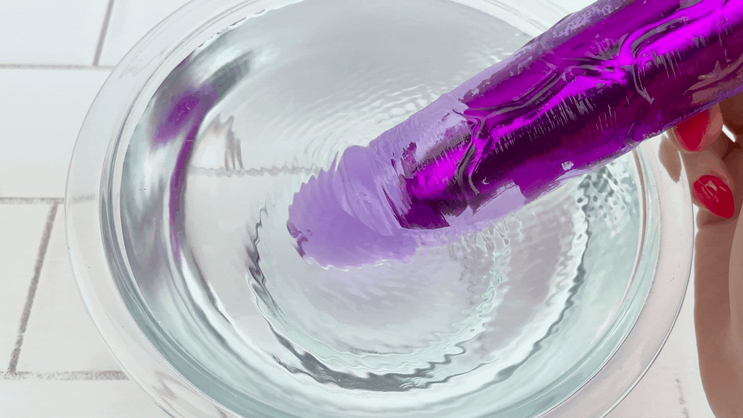 GIF of 8 Inch Long Deep Penetration Vibrating Dildo tip vibrating in bowl of water 