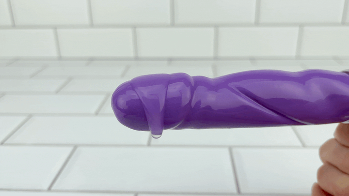 GIF of lubricant from TooTimid on tip of Purple Vibrating Dildo with flexible shaft 