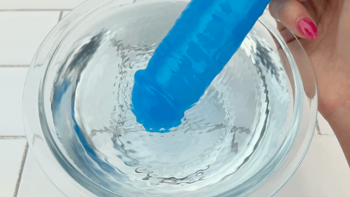 GIF of Thick Vibrating Dildo tip vibrating in bowl of water 