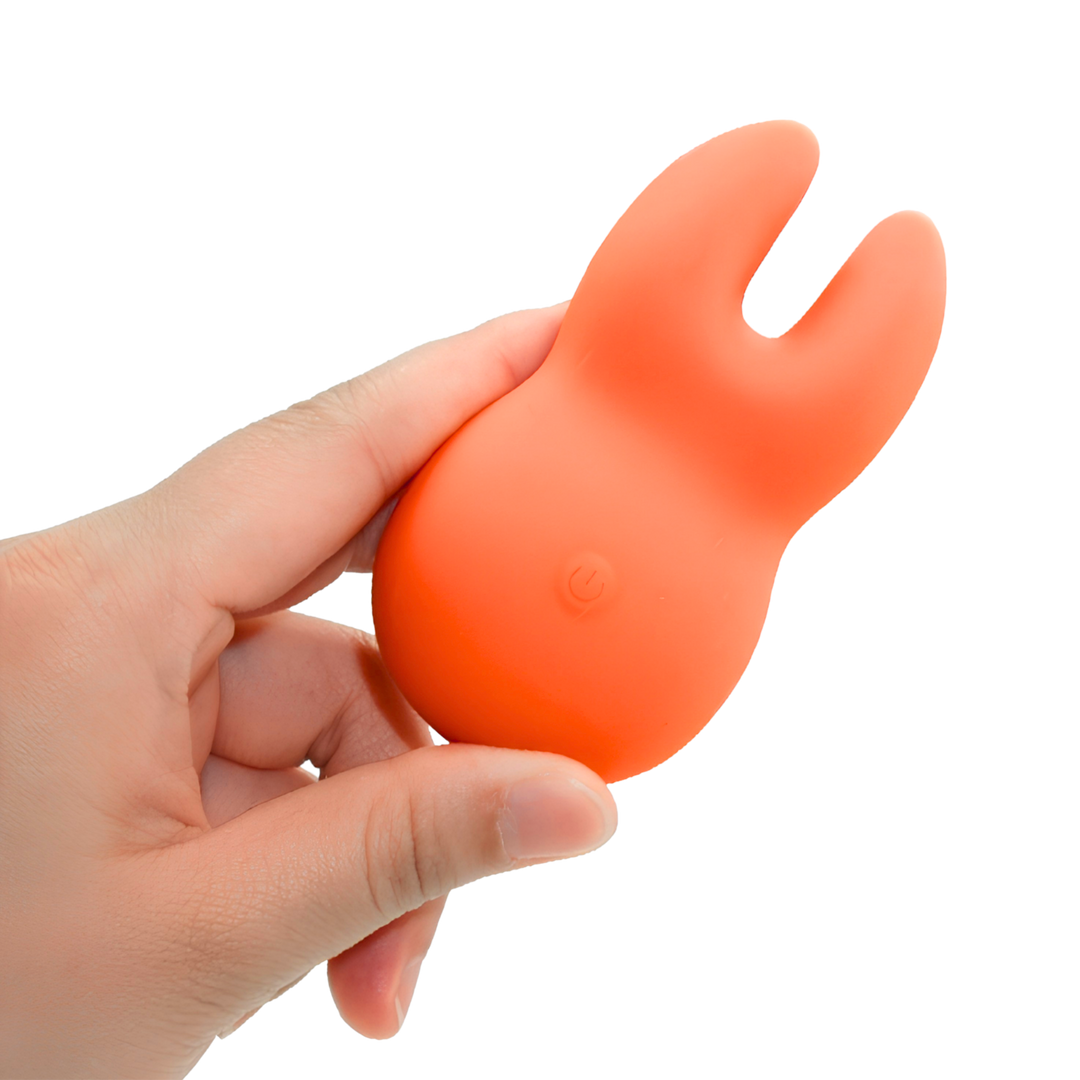 hand holding Clit-Encasing Vibrator 