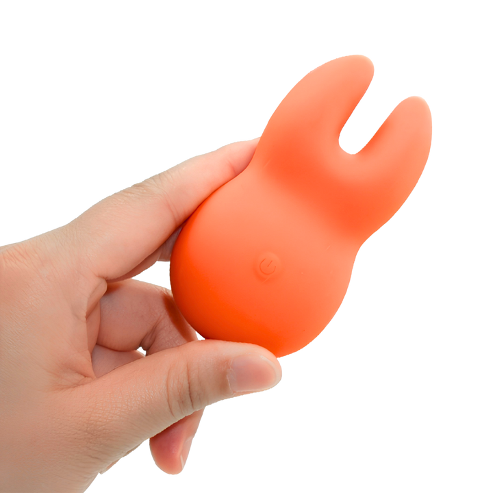 hand holding Clit-Encasing Vibrator 