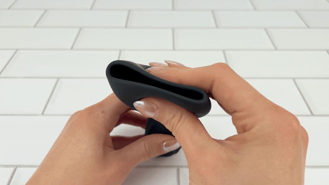 GIF of Vibrating Penis Tip Massager being squeezed to show soft silicone texture 