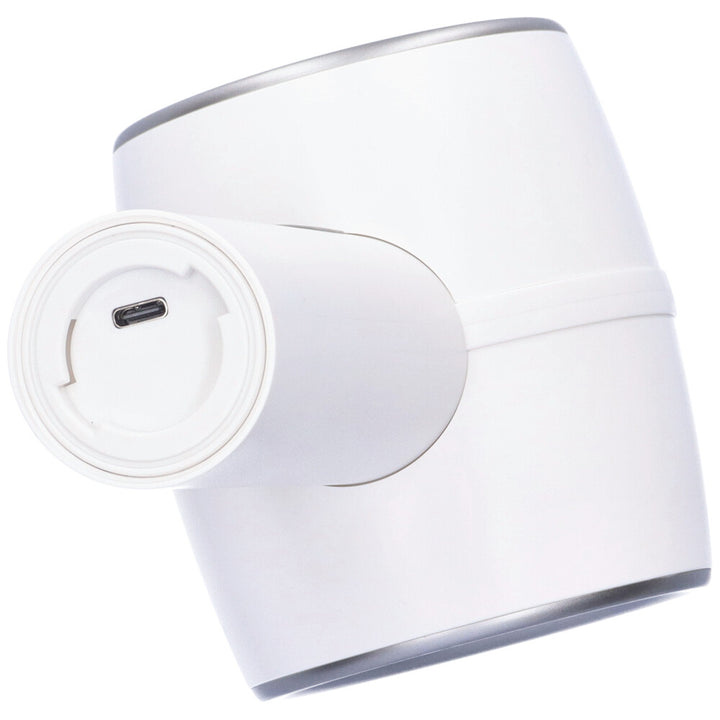 Bottom view of a white thrusting masturbator showing the charging port.
