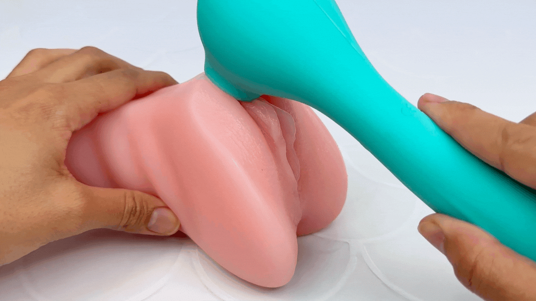 GIF of flickering tongue/air pulse end massaging a model of a clitoris