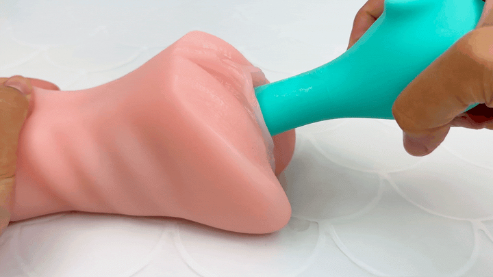 GIF of G-spot massager end penetrating a model of a vagina.
