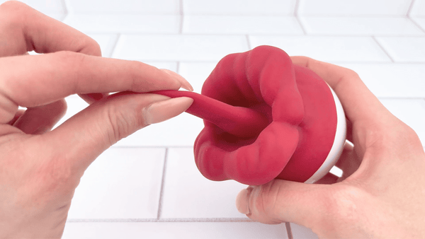 GIF of tingue being pulled from Flaming Red Lips Self-Motion Flickering Tongue Clit Stimulator to show softness 
