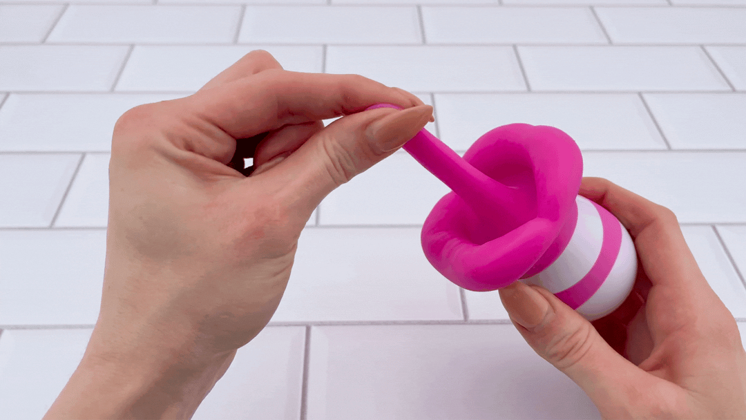 GIF of hand pulling soft tongue from Goodnight Kiss Clitoral Licker