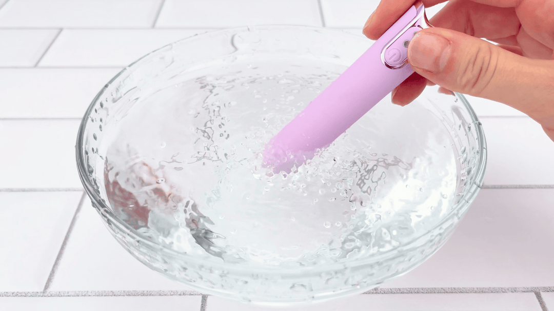 GIF of lavender silicone bullet vibrating in a clear glass bowl of water