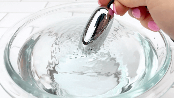 GIF of silver bullet vibrating in a bowl of water