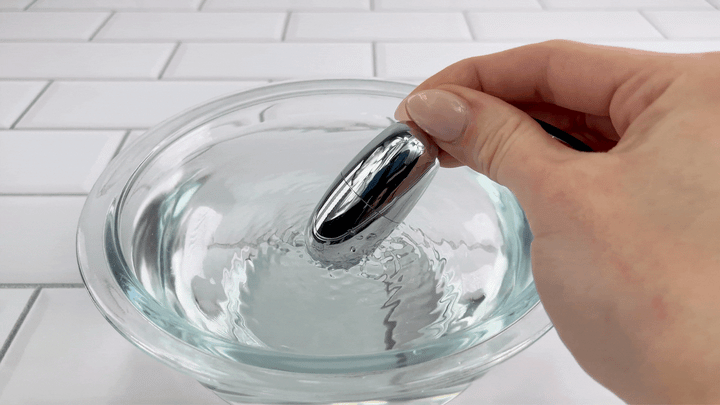 GIF of bullet vibrator vibrating in bowl of water 