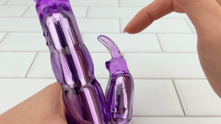 GIF pointer finger brushing against Wonder Rabbit Dual Stimulator bunny ears 