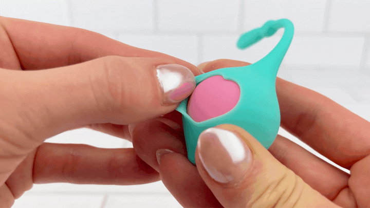 GIF of flap from SORA Combination Duo Tone Kegel Ball and Pleasure Ball Exerciser Set being flexed to show soft silicone 